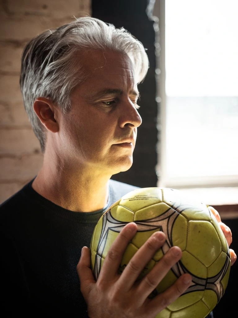 Director of Coaching standing on a youth soccer pitch